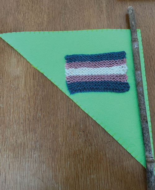A Pride pendant banner showing the Trans flag